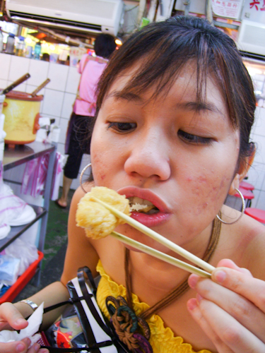 Taking the first bite of stinky tofu